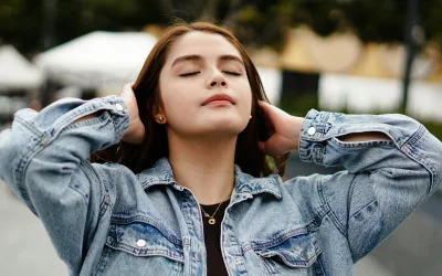 Young woman with eyes closed enjoying a serene moment outdoors