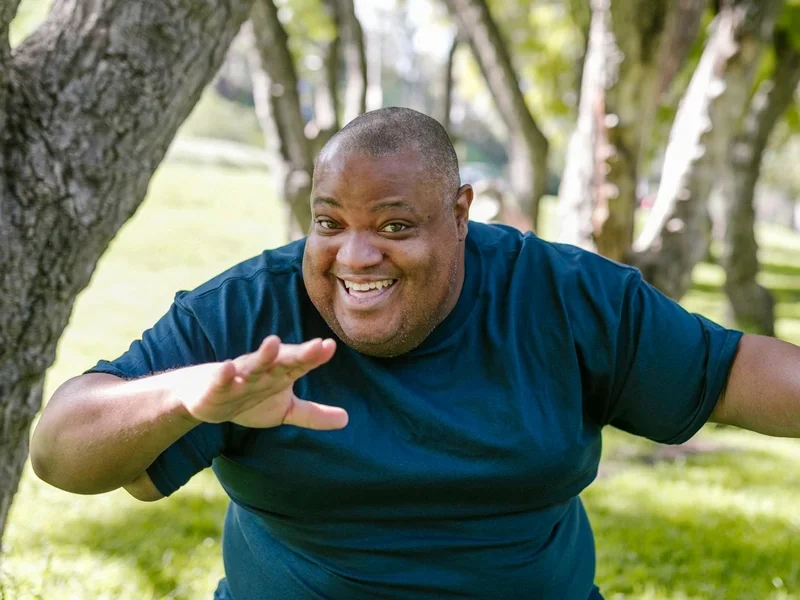 Smiling man enjoying a sunny day in a park