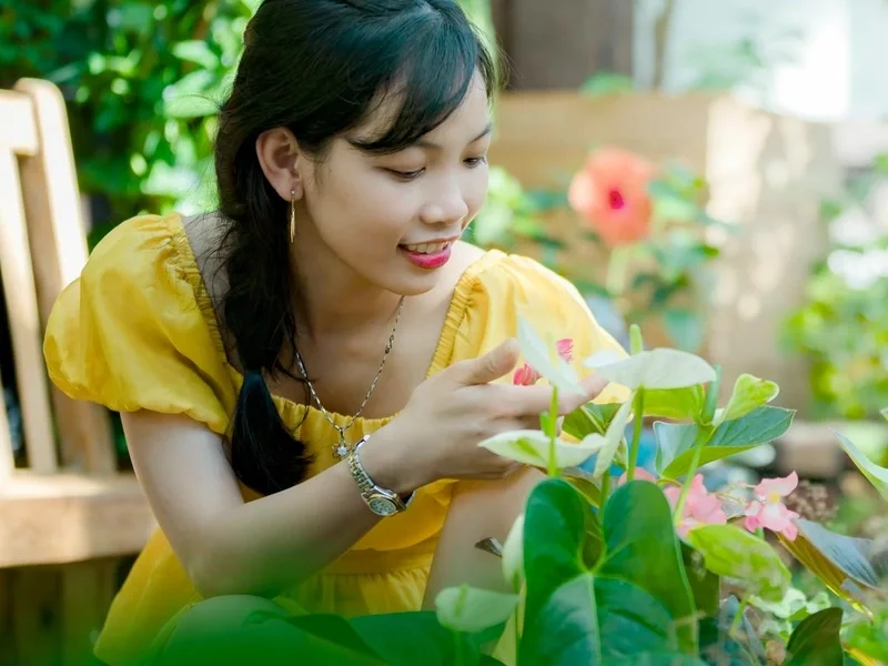 Woman tending to plants in a summer garden