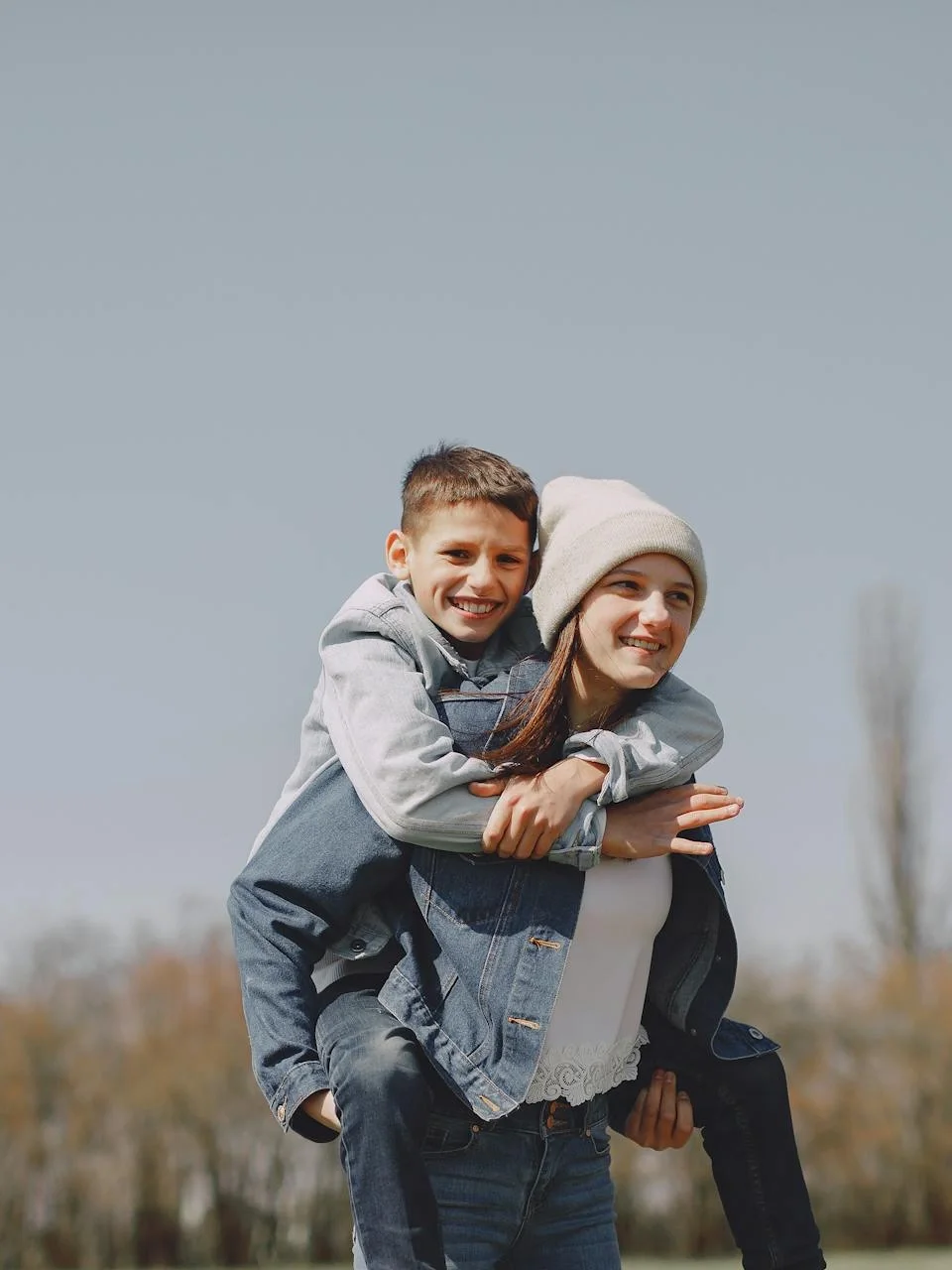 Children piggyback riding together in the countryside
