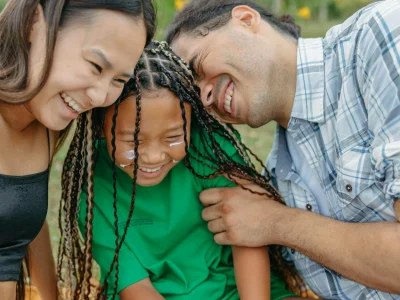 Joyful family spending time together in a sunny park, embracing happiness