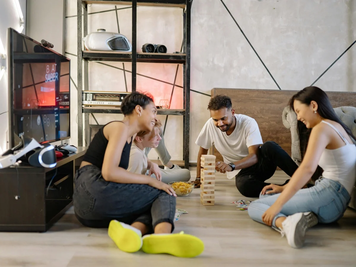 Diverse group of friends playing games and having fun together indoors
