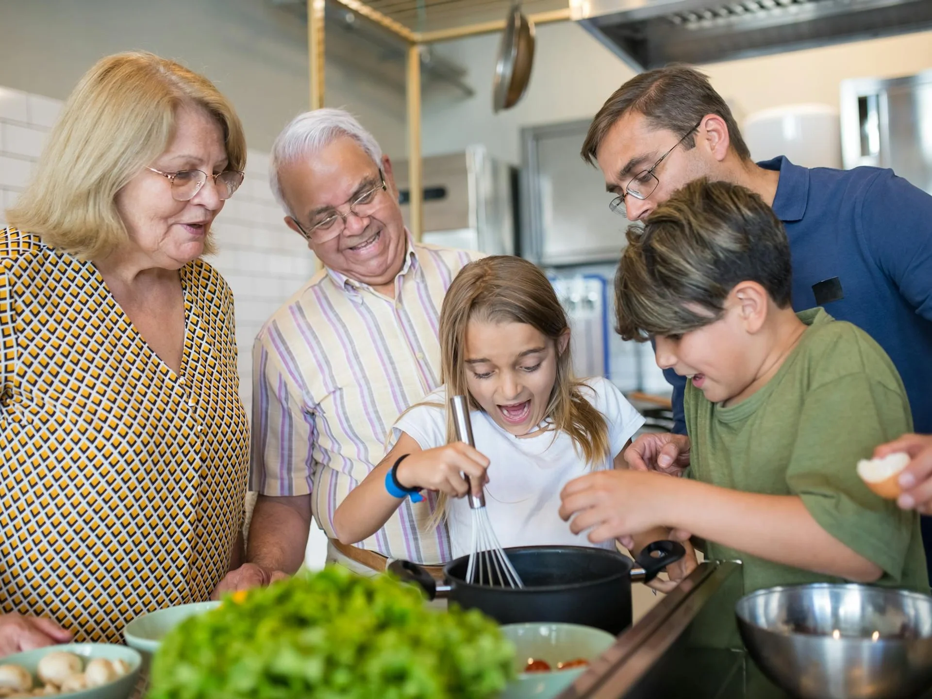 Multigenerational family bonding while cooking together in a home kitchen