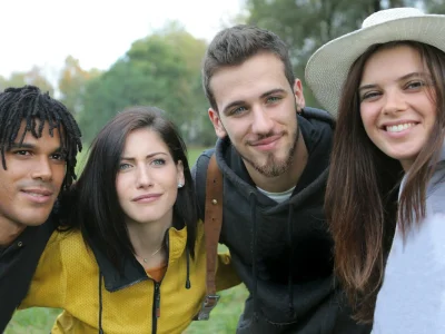 Diverse group of young friends taking a selfie together in the park