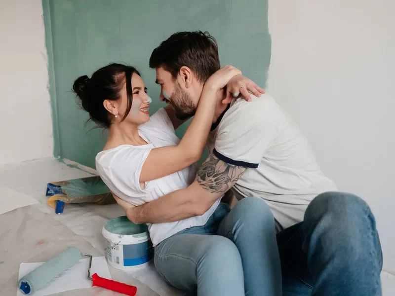 Couple painting a room together during a home renovation