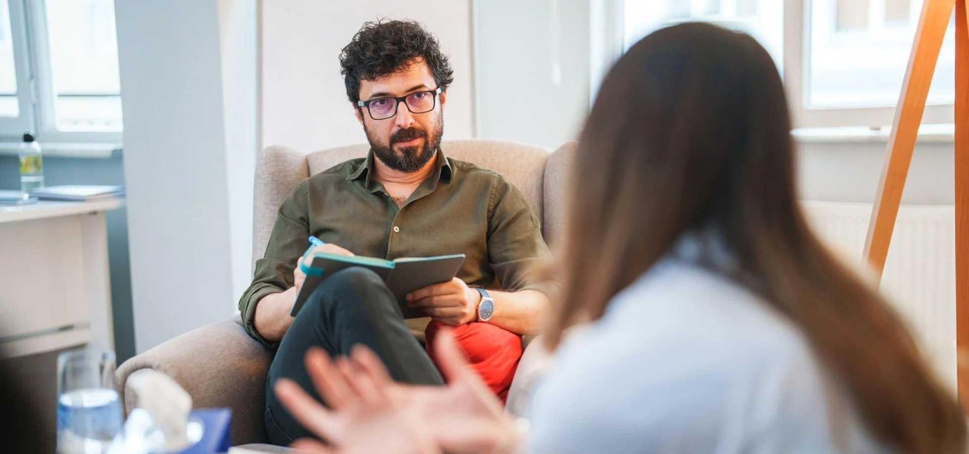 Therapist and client in a warm, supportive counseling session