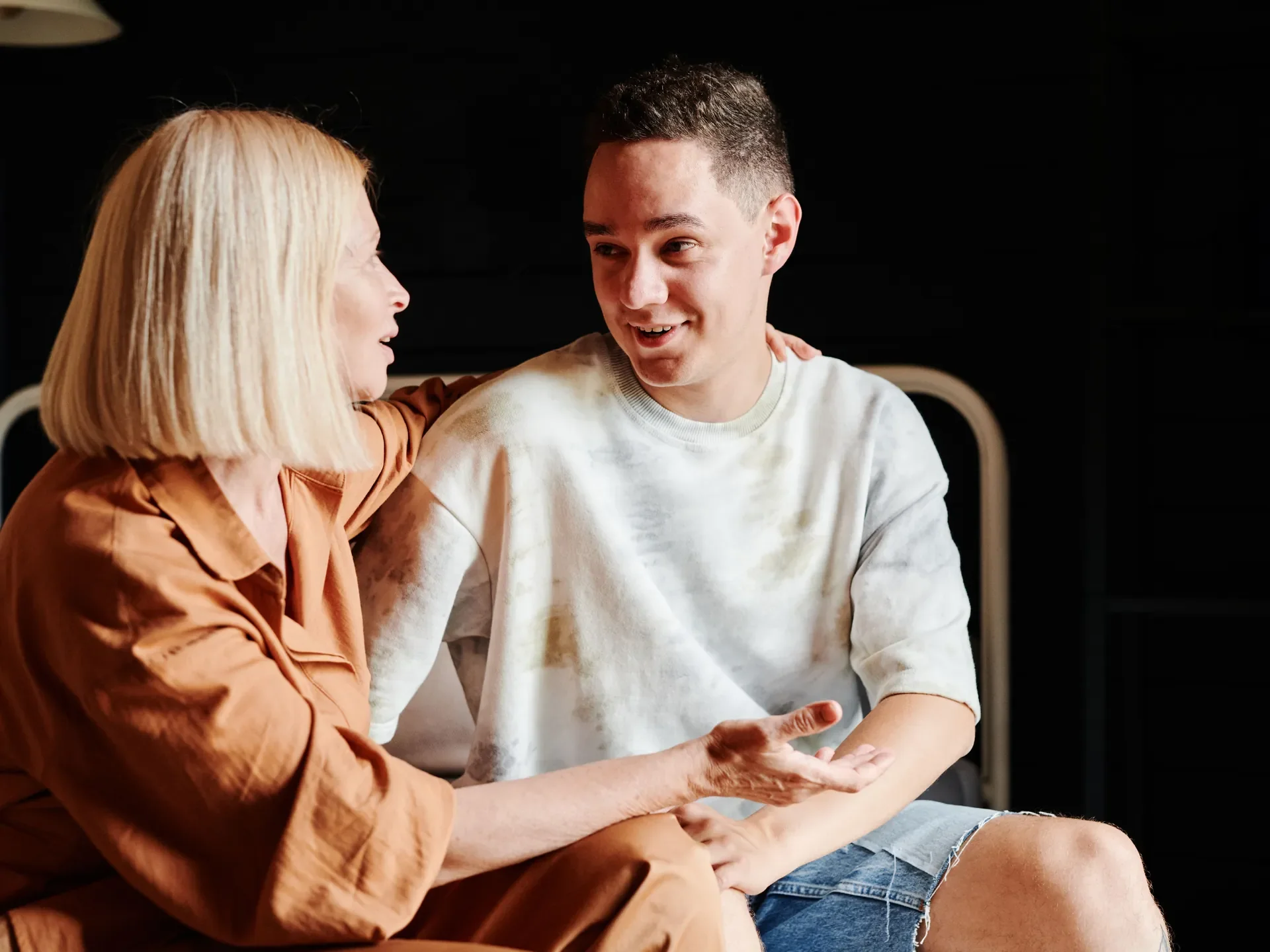 A mother and her teenage son in a warm, supportive conversation