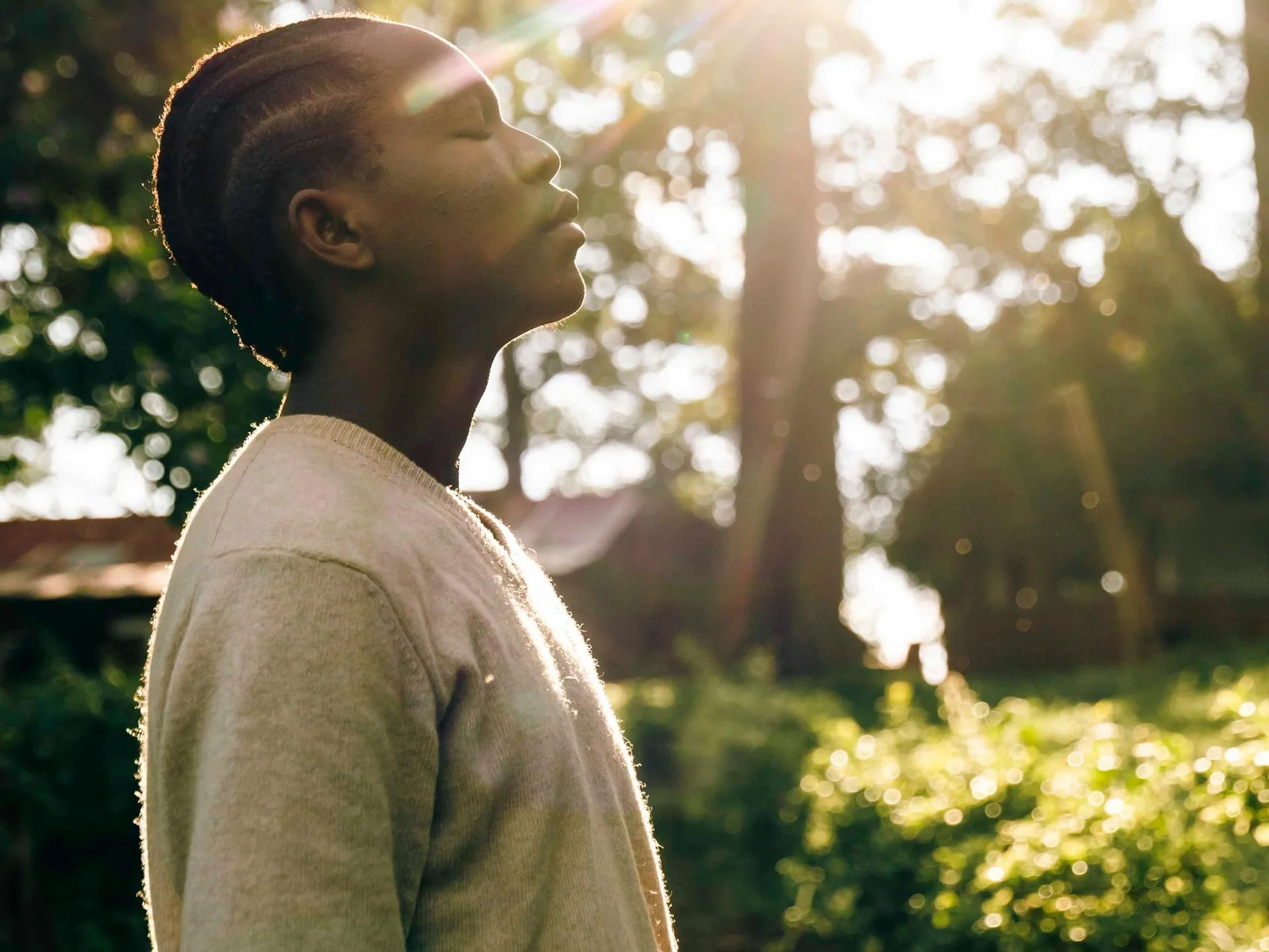 Person enjoying sunlight in a peaceful outdoor setting