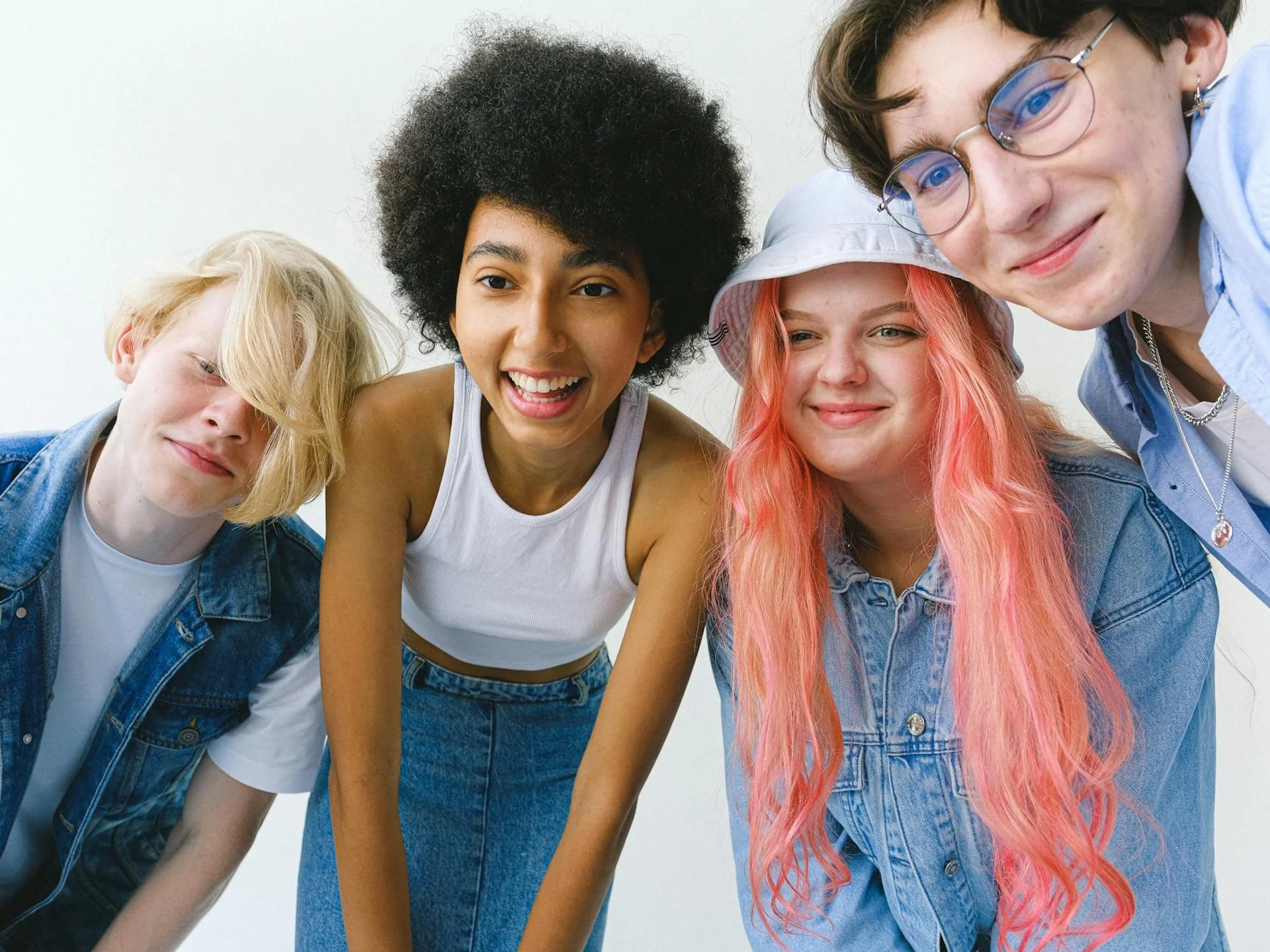 Diverse teenagers standing together confidently against a white wall