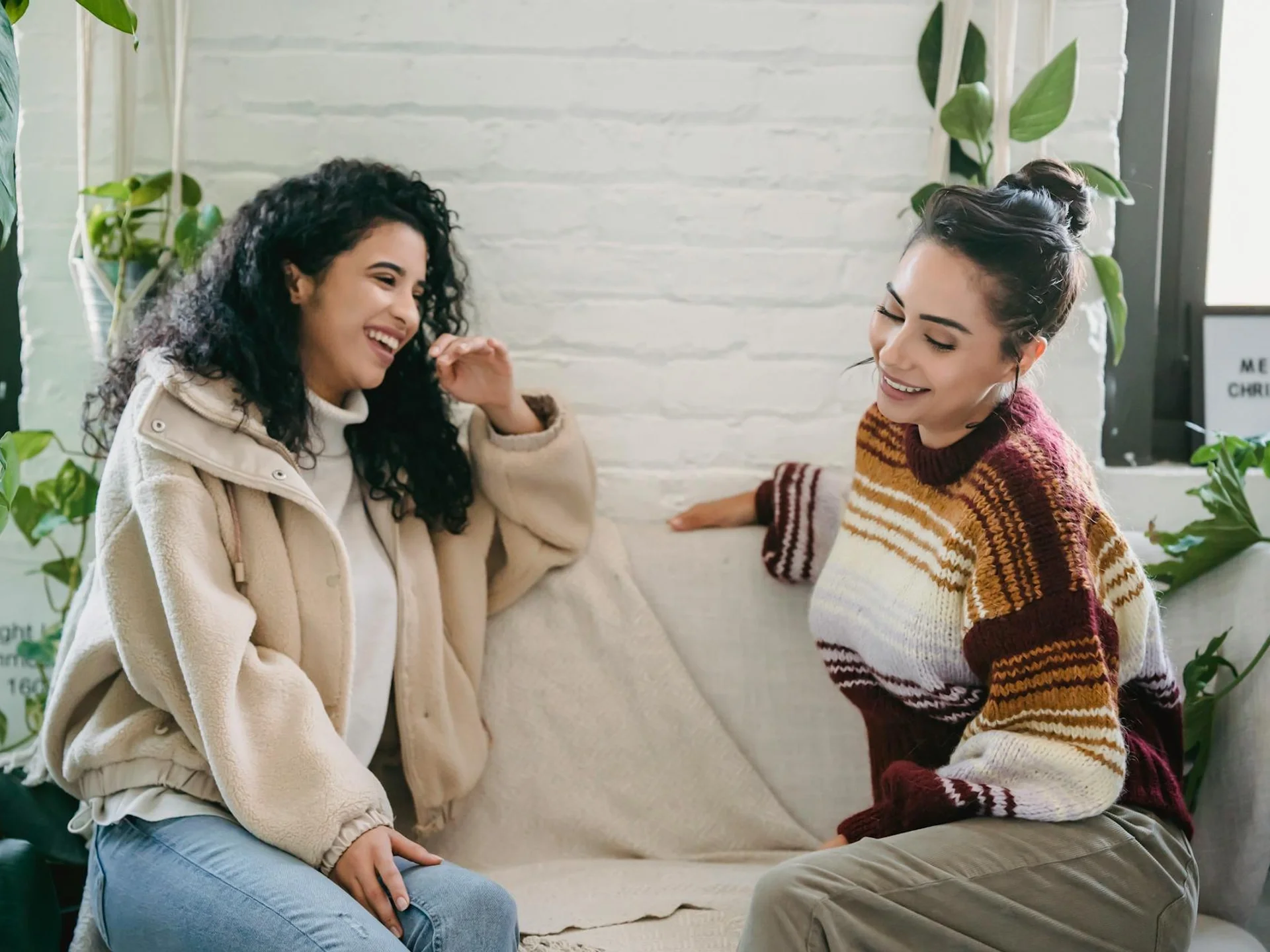 Young woman having a caring conversation on a sofa